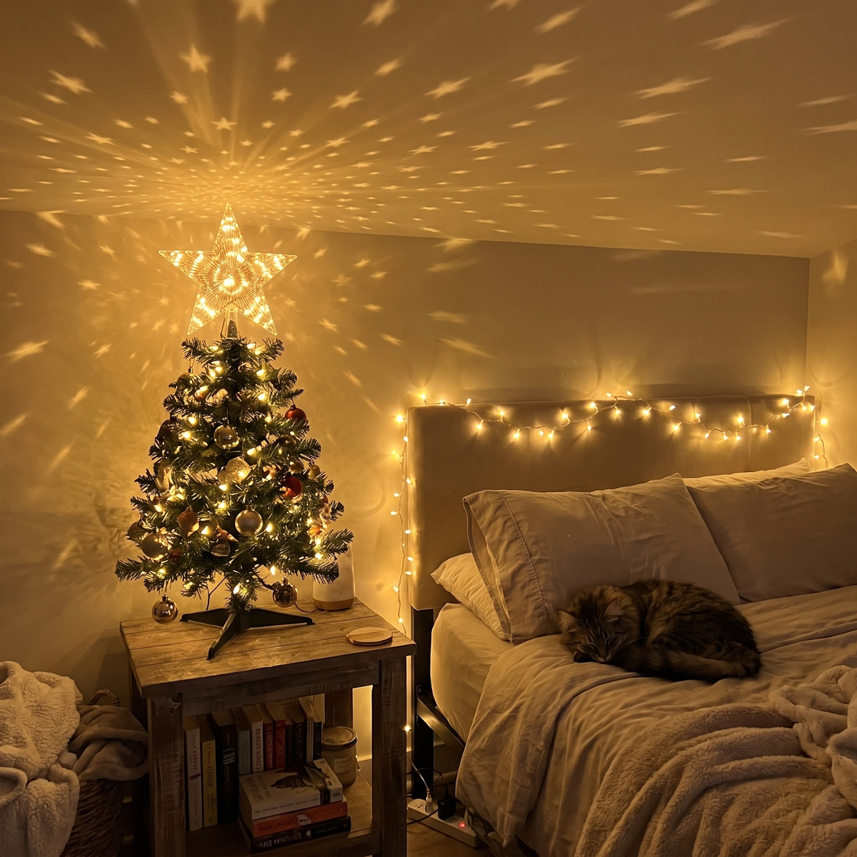 Small tabletop tree lighting up a bedroom ceiling with stars