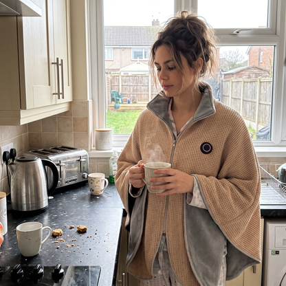 Woman in a kitchen wearing the CozyEmber heated shawl