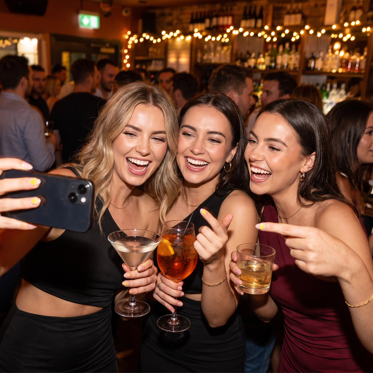 Friends showing SipSure heart stickers on a girls night