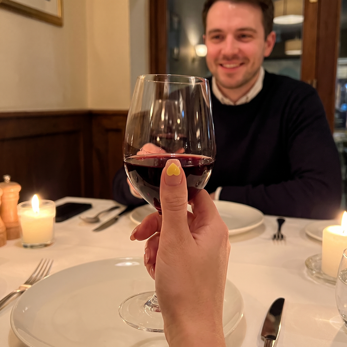 SipSure heart sticker on a nail on a dinner date